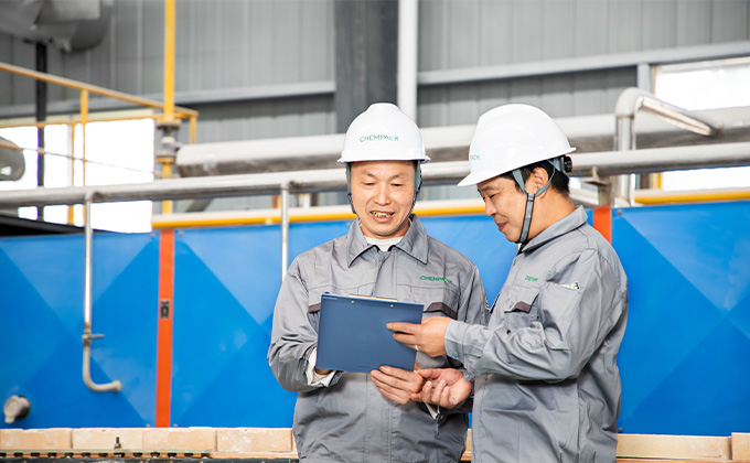 two workers happily discussing processing showing our employee protection and motivation